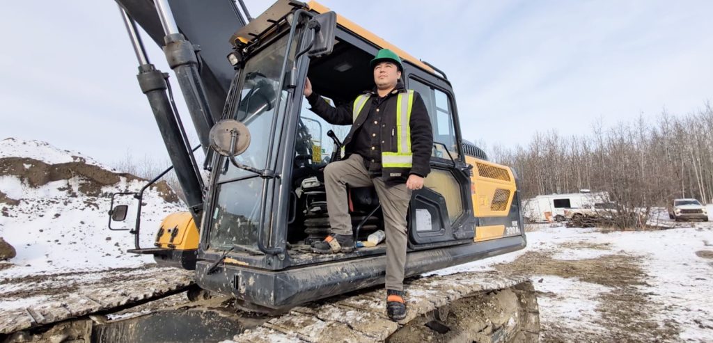 Worker on excavator looking to the future.